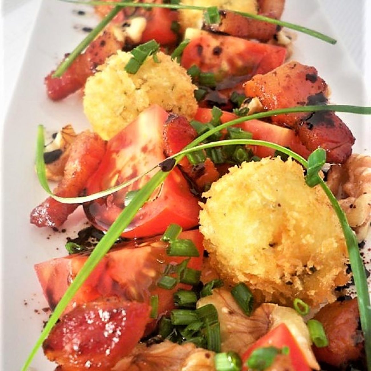 Tomato Salad with goat cheese, pancetta and walnuts