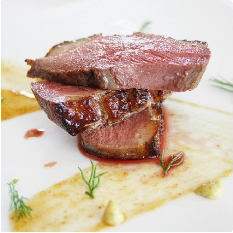 Sliced medium-rare steak with a crisp sear and delicate herbs