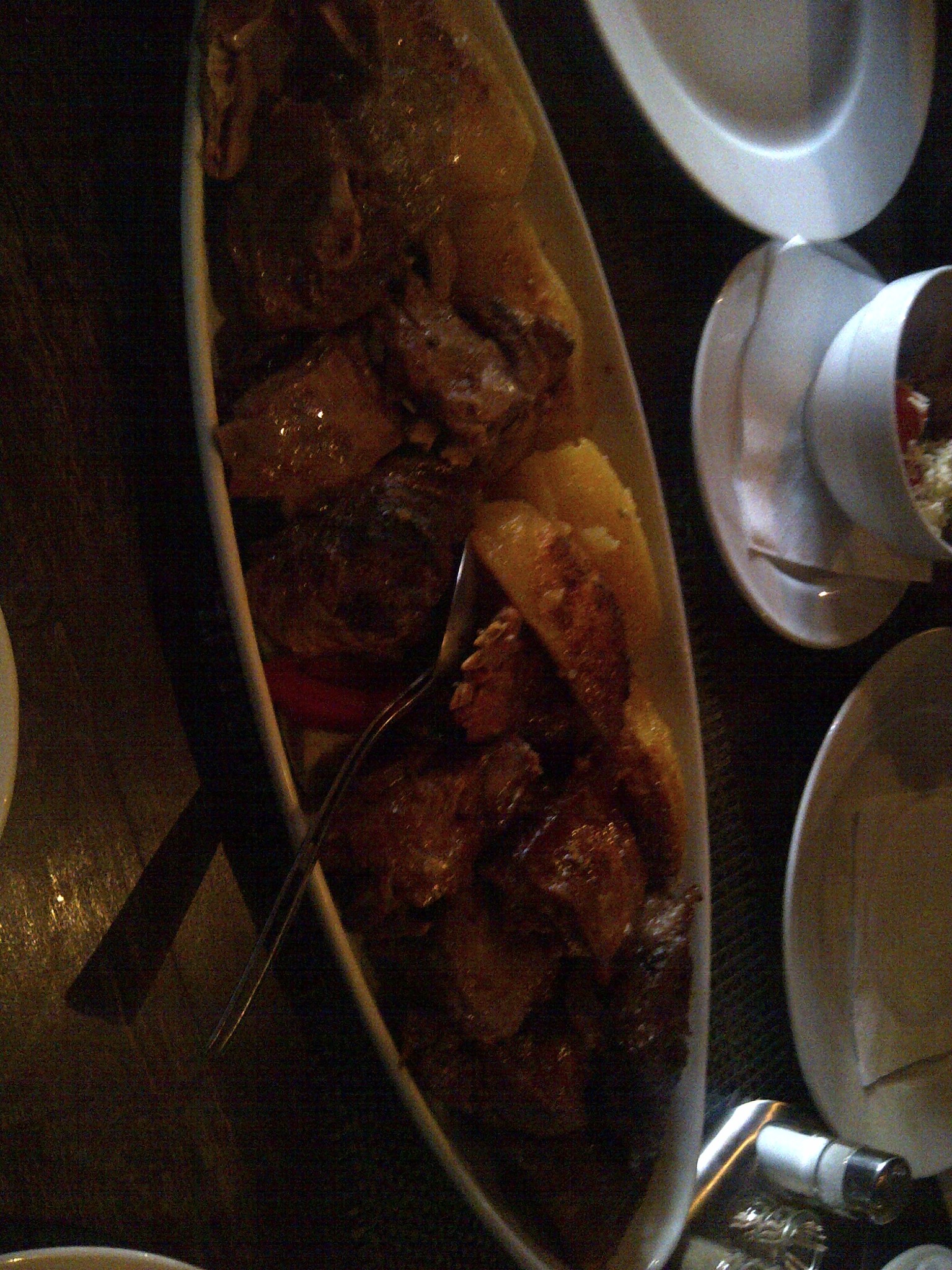 A platter of grilled meats and potatoes