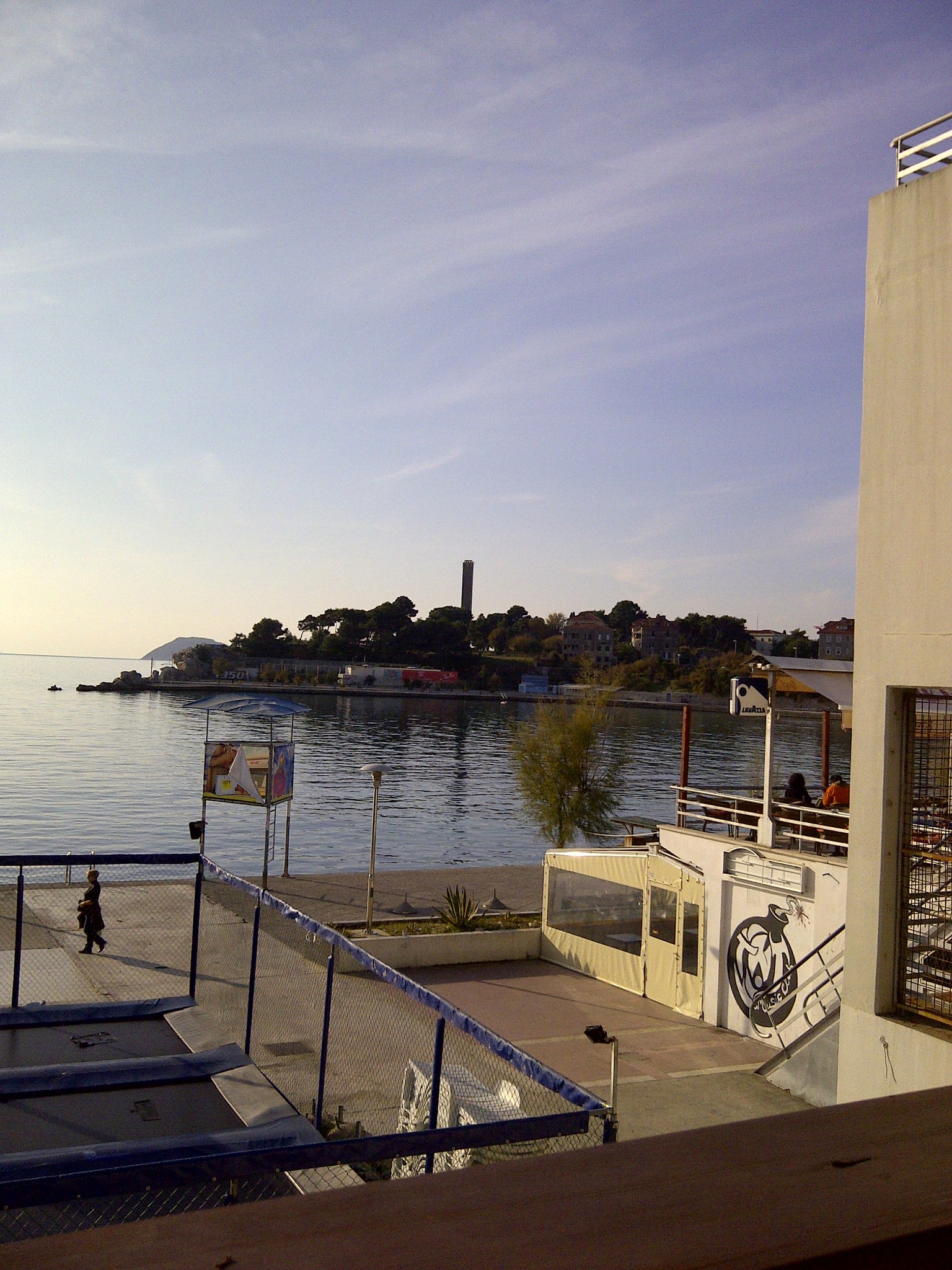 A calm waterfront and buildings across the bay