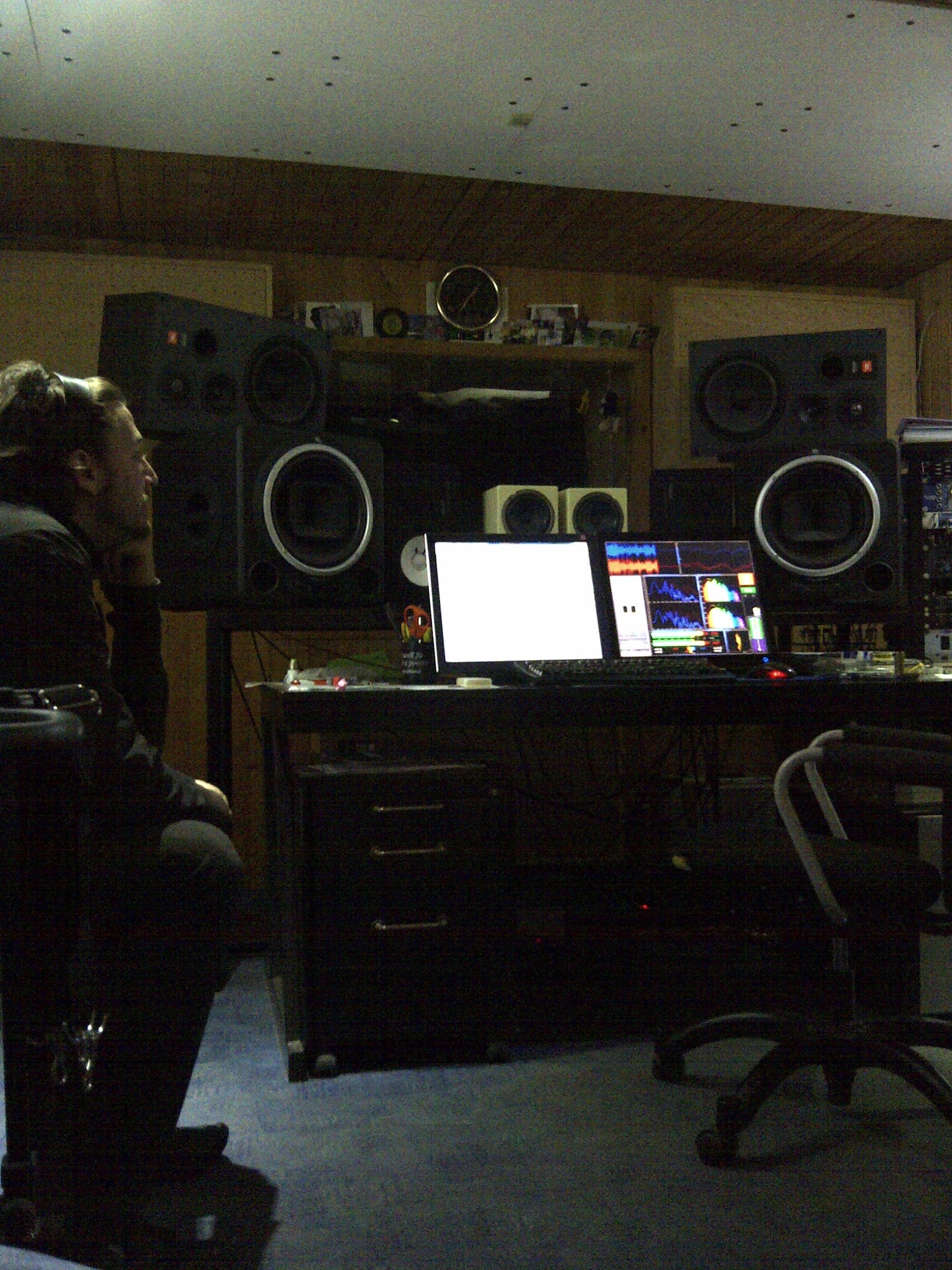 A recording studio control room with large monitor speakers