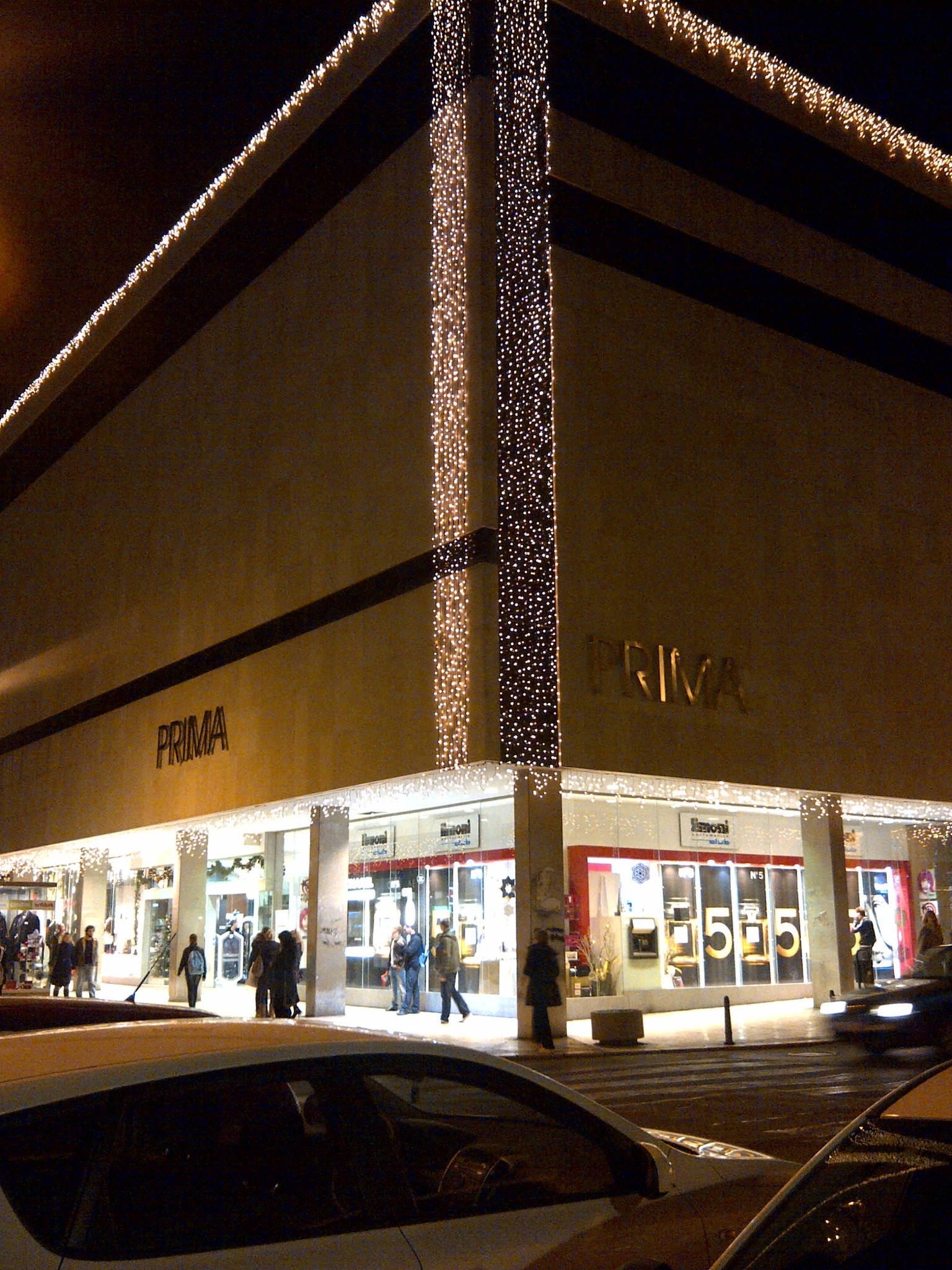 A brightly lit shopping center at night
