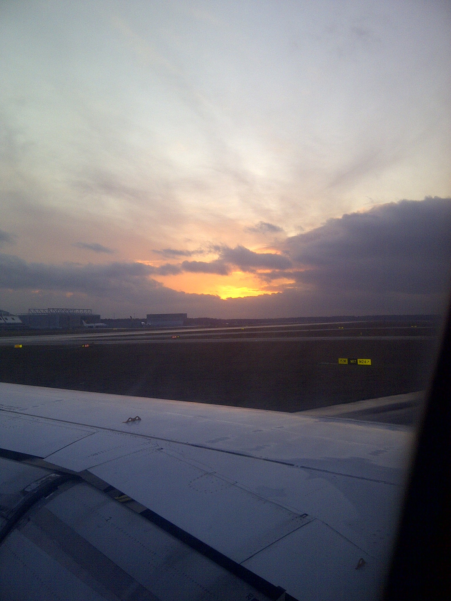 Sunrise seen beyond an aircraft wing