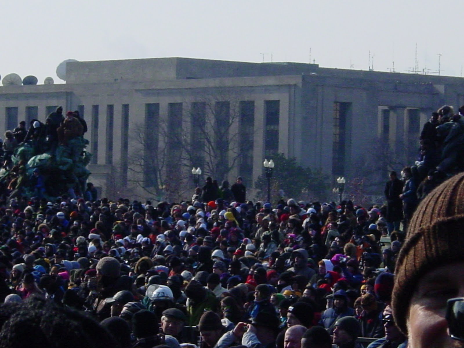 Dense winter-coated crowd facing the monumental buildings in Washington