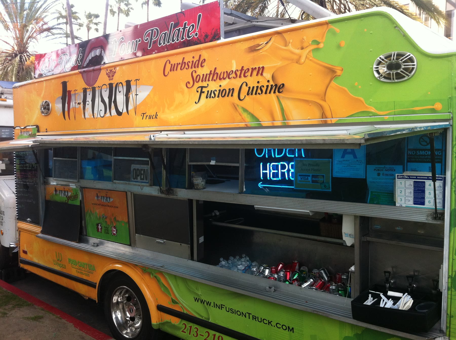 The InFusion truck with its service window open and ORDER HERE sign illuminated.