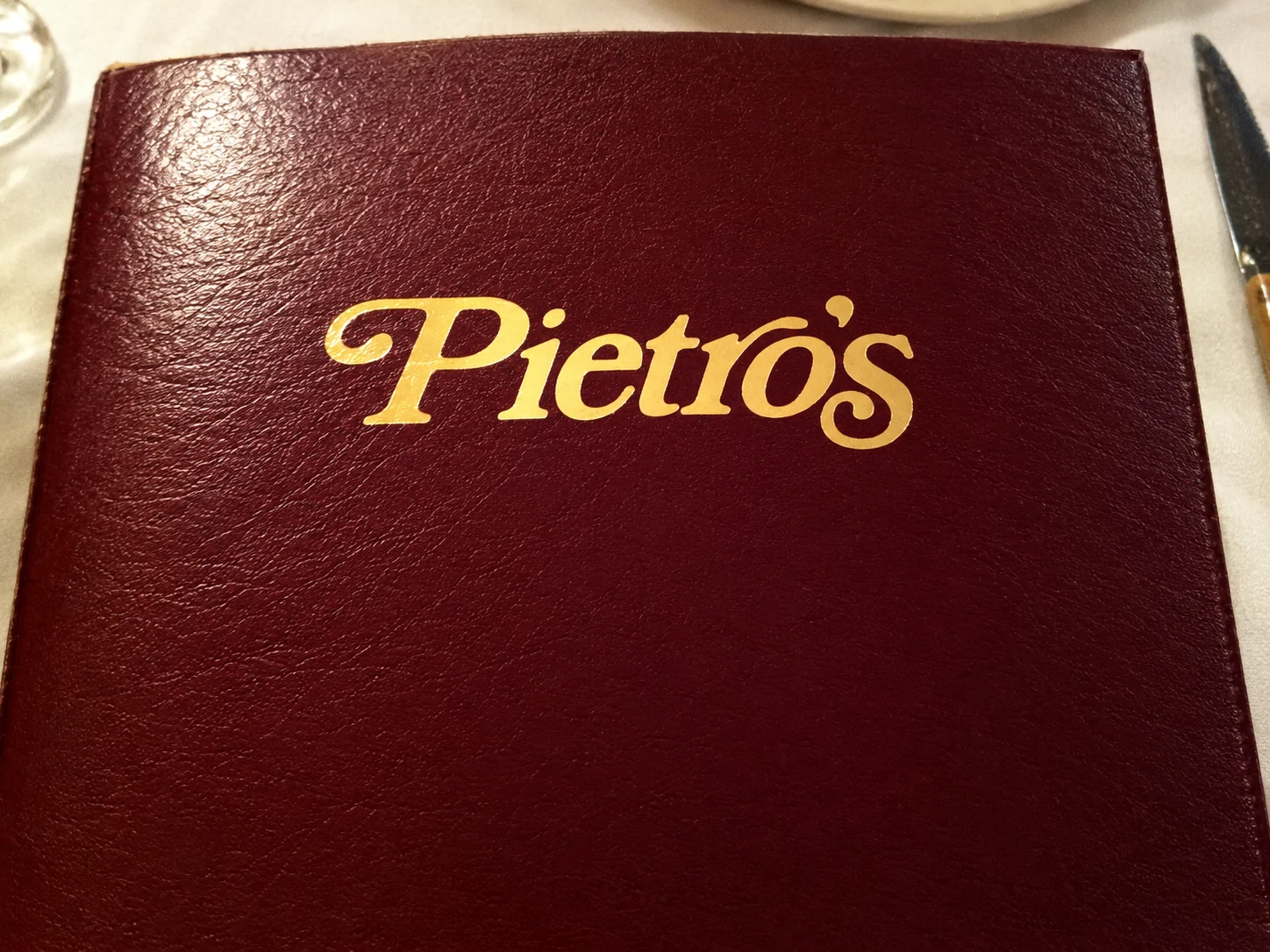 Burgundy Pietro’s menu cover with its name stamped in gold