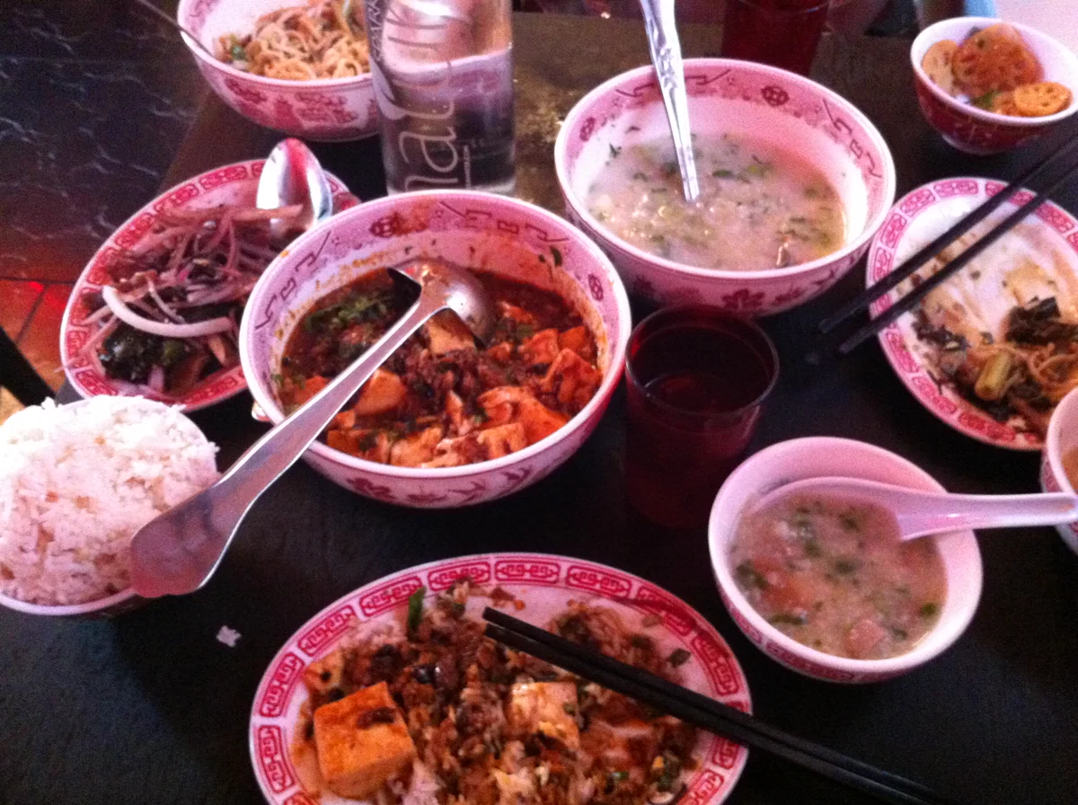 A table filled with dishes at Mission Chinese Food on Orchard Street in 2012