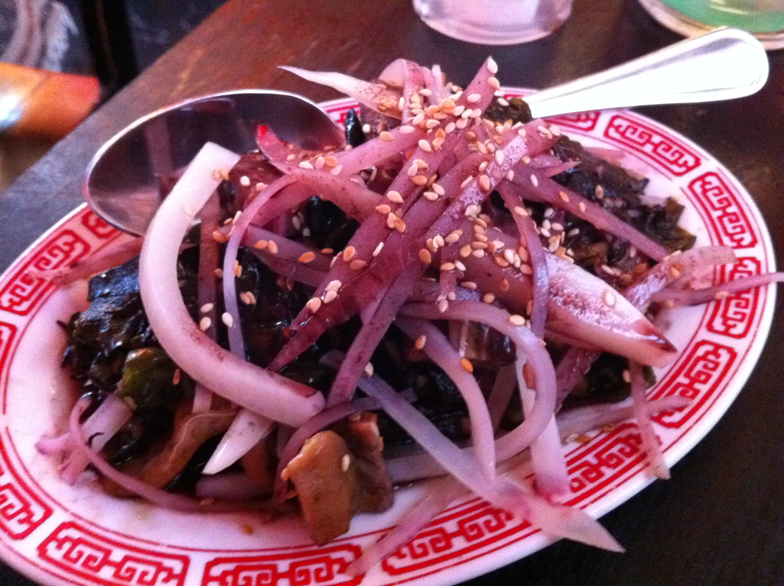 Vegetables topped with red onion and sesame