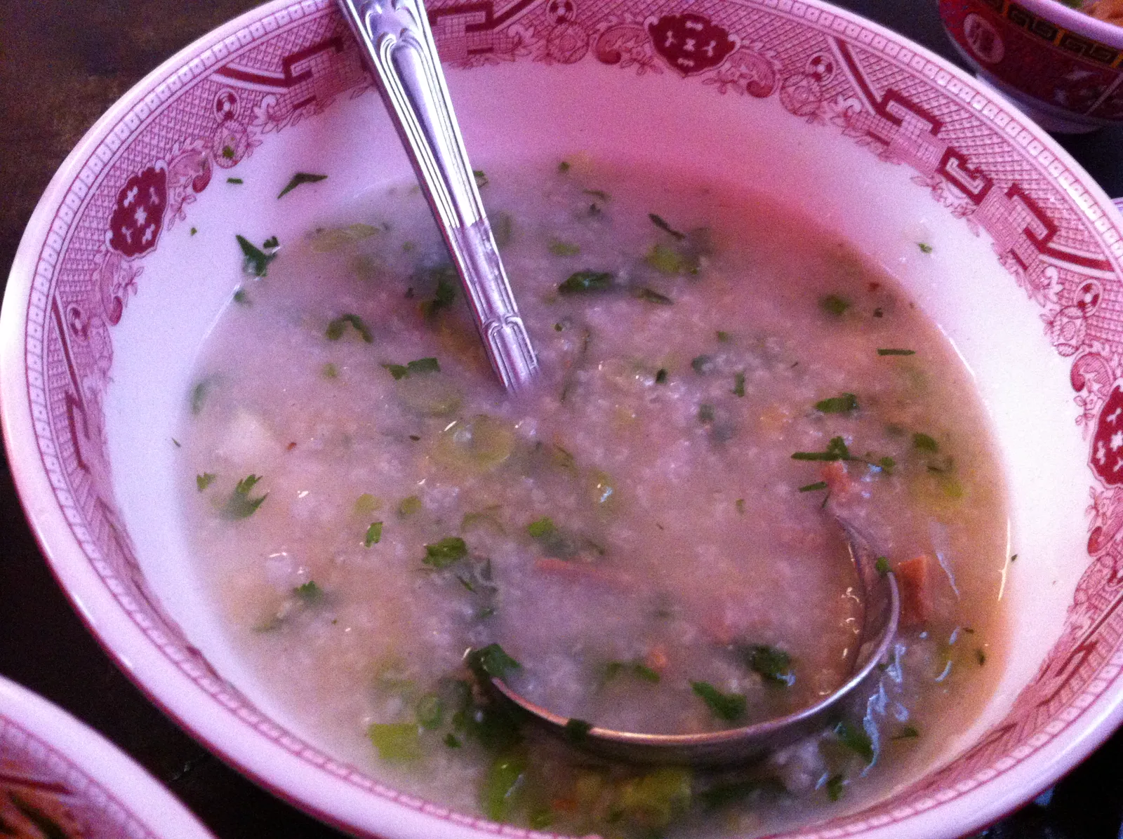 A bowl of rice porridge with herbs