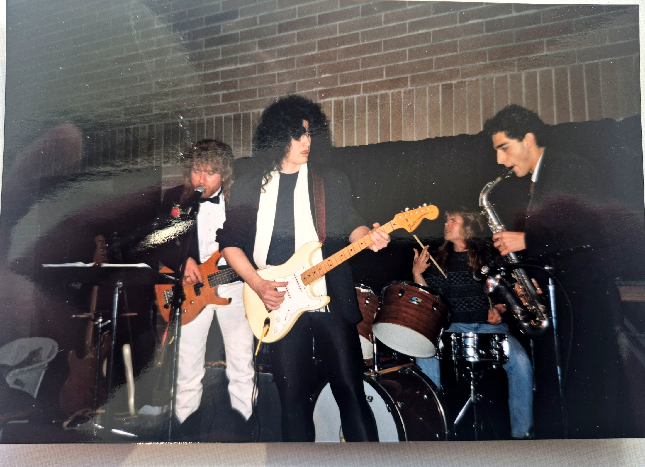 Tim Steinrock singing, Benny Doro playing a white guitar and Jeff Worobec on drums during the 1990 production.