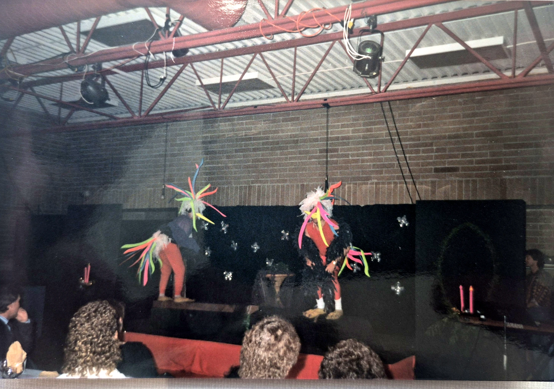Performers in colorful costumes on stage.