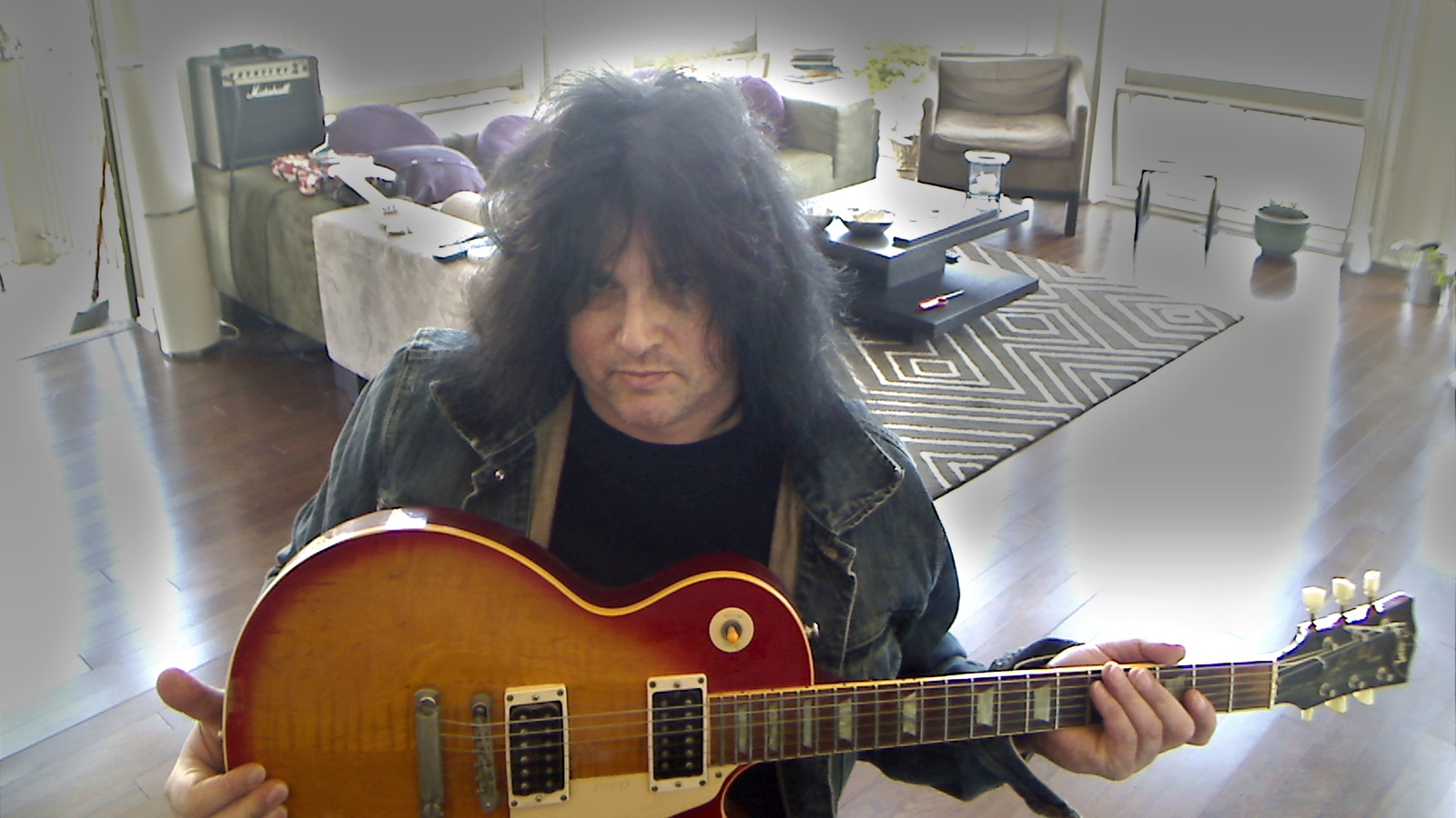 Benny Doro holding his Les Paul in his West New York apartment in 2012.