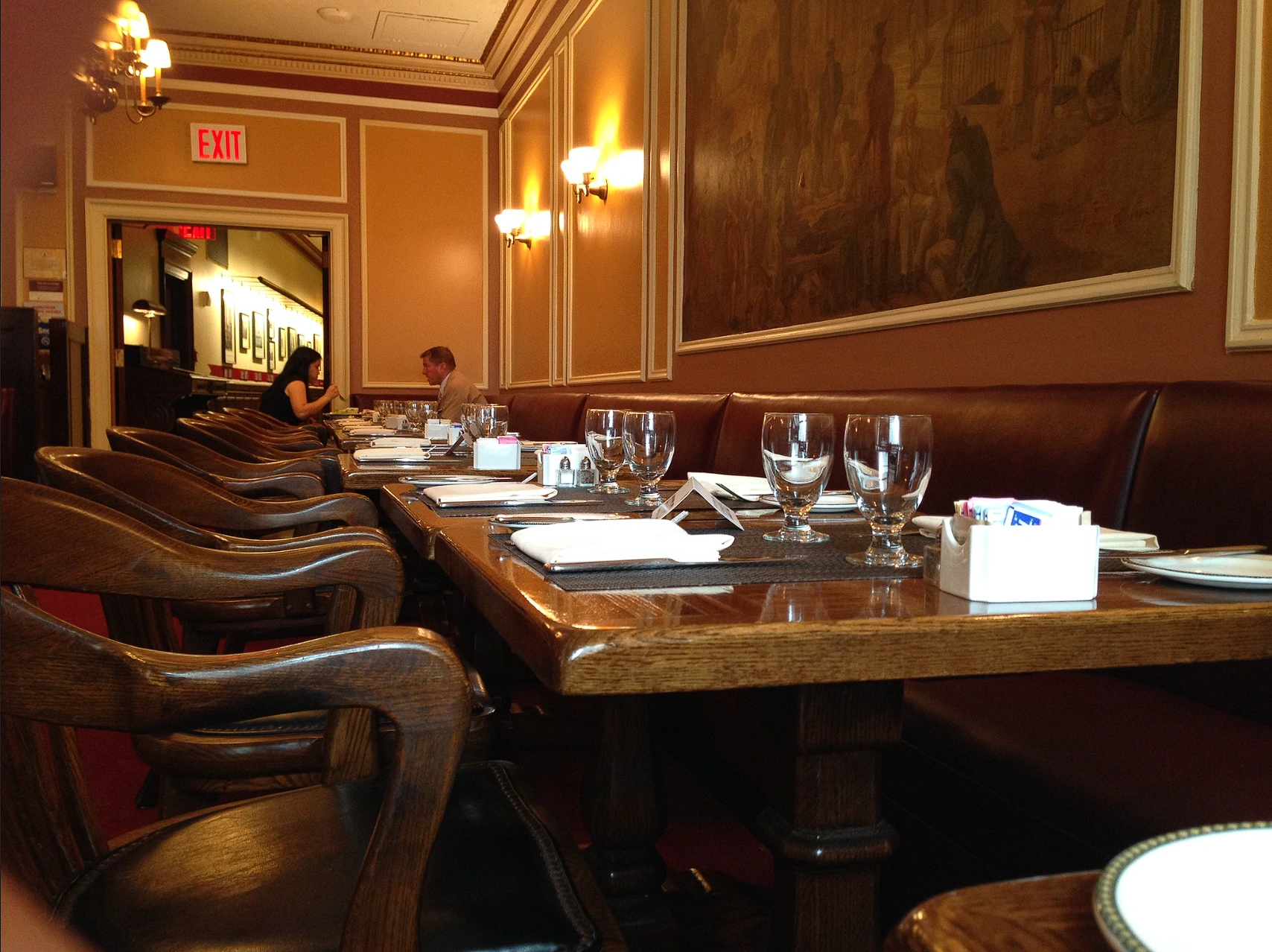 The warm interior of 1792 with wooden chairs, set tables, leather seating and a large framed painting