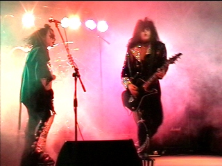 Black Diamond performing under red stage lights, photograph 2 of 22