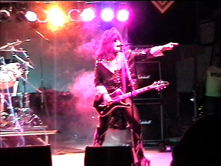 Benny Doro pointing toward the crowd as Paul Stanley, photograph 22 of 22