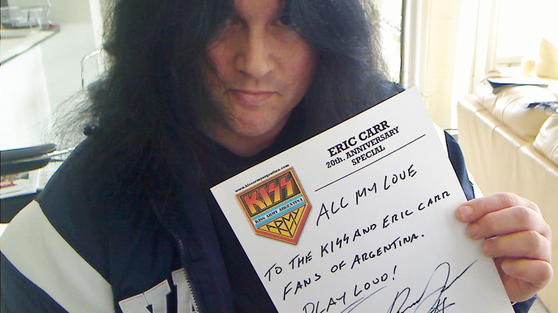 Benny Doro holding a handwritten dedication to KISS and Eric Carr fans in Argentina.