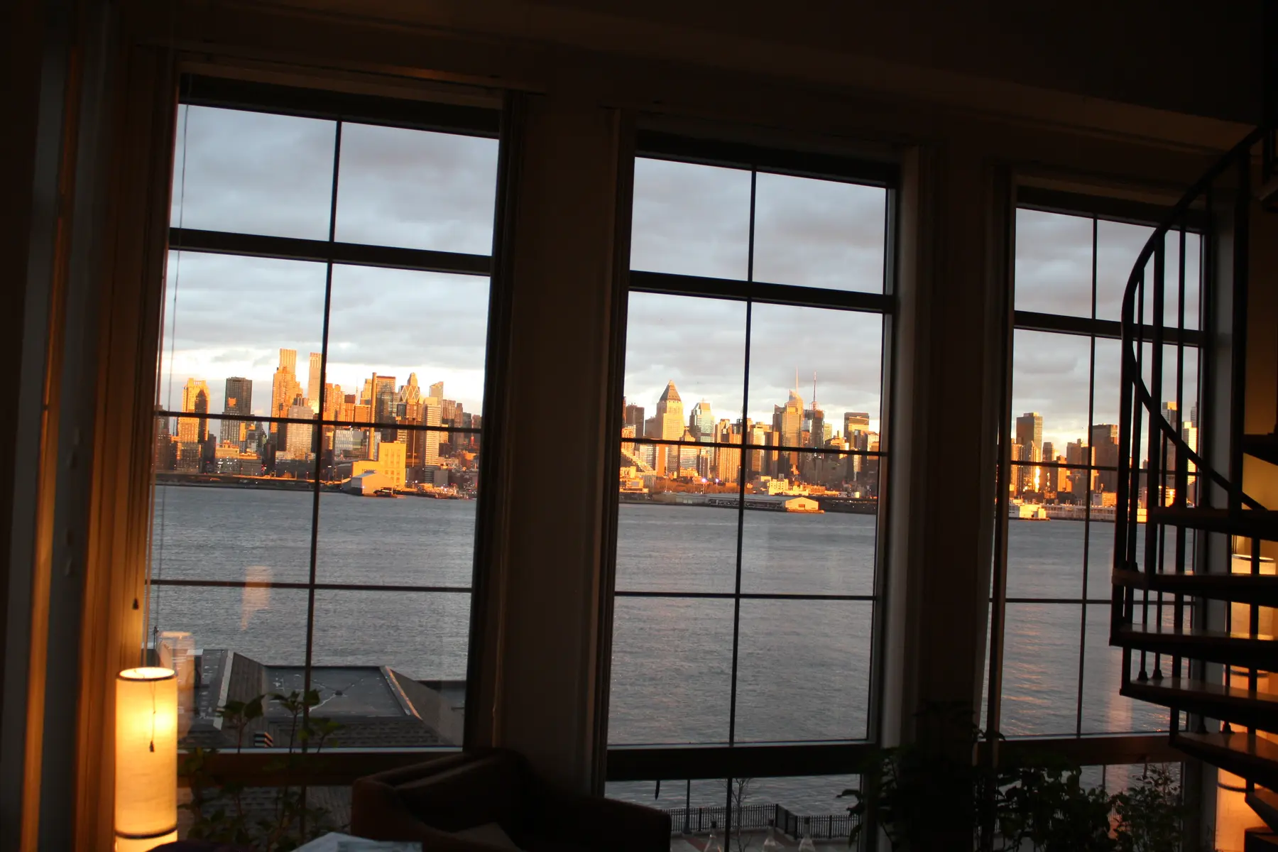 Manhattan framed by the tall windows inside Benny's home at Port Imperial.
