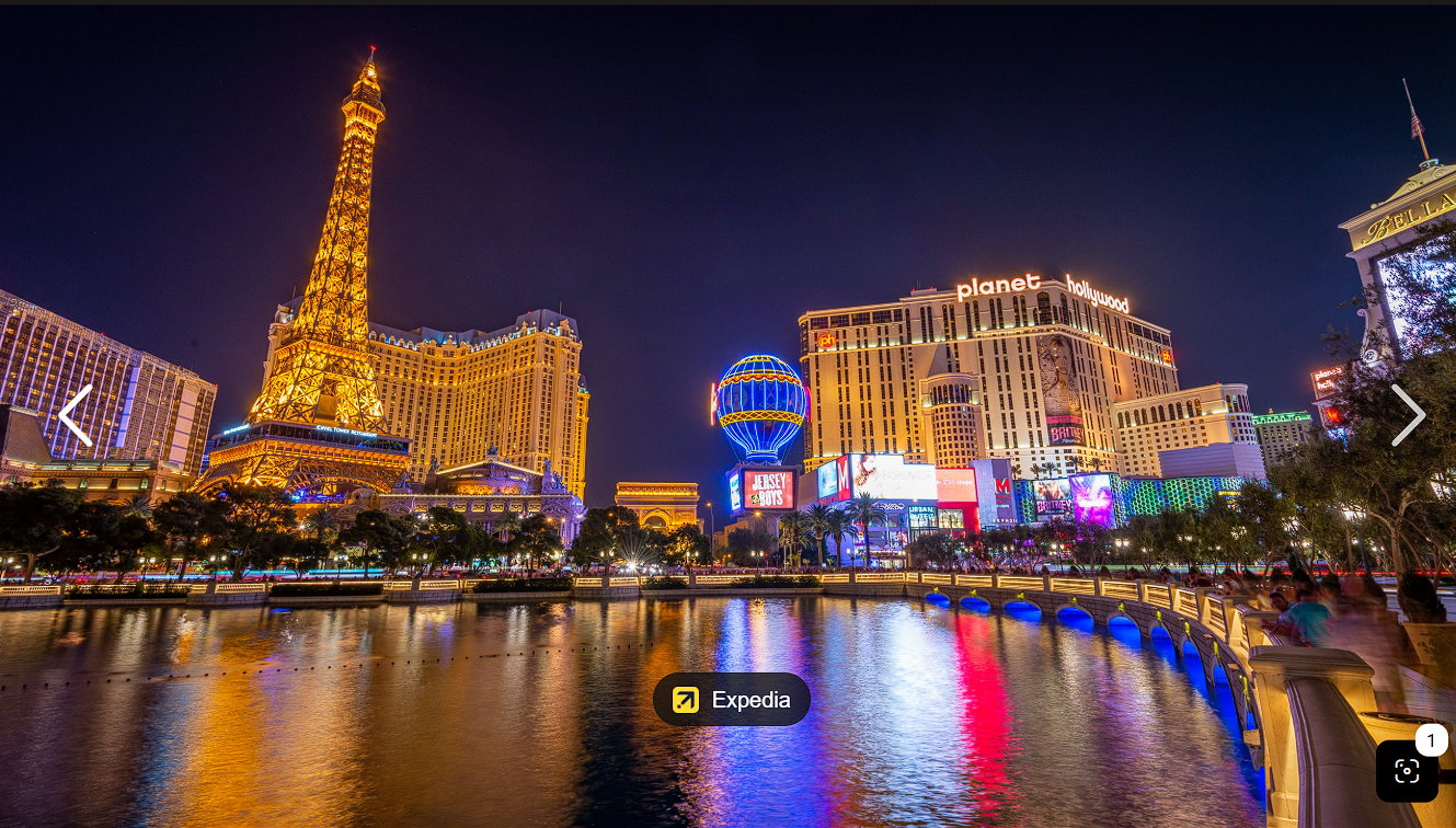 Supplied nighttime Las Vegas Strip atmosphere reference: Paris Las Vegas and Planet Hollywood illuminated across the water.