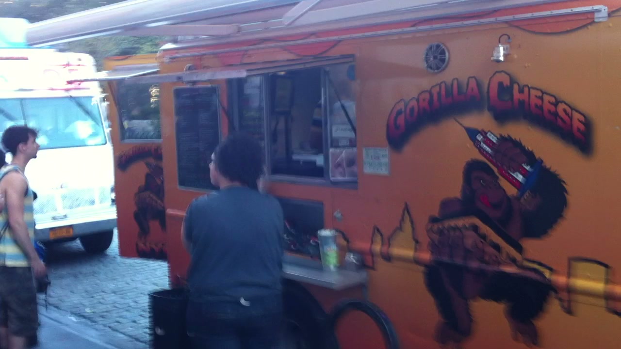 Customers line the curb beside food trucks at Union Square in September 2012.